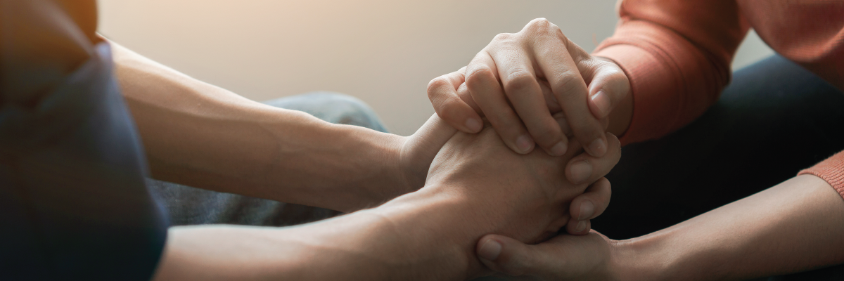 Hands holding hands in support