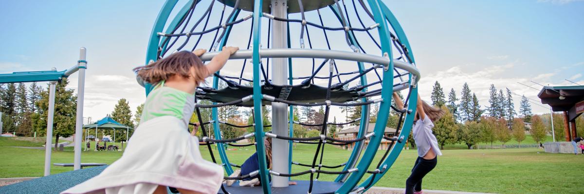 Children playing on playground equipment at park