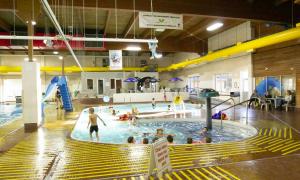 indoor pool with children swimming and playing