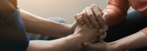 Hands holding hands in support